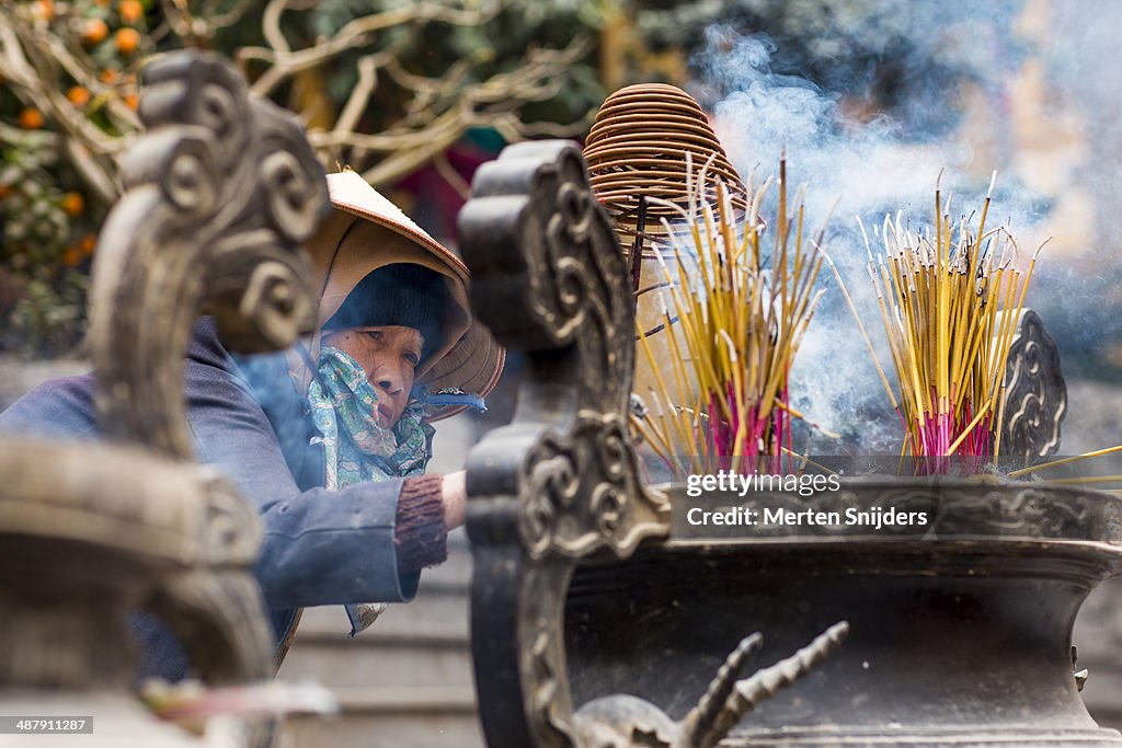Volunteer woman organizing incense bin