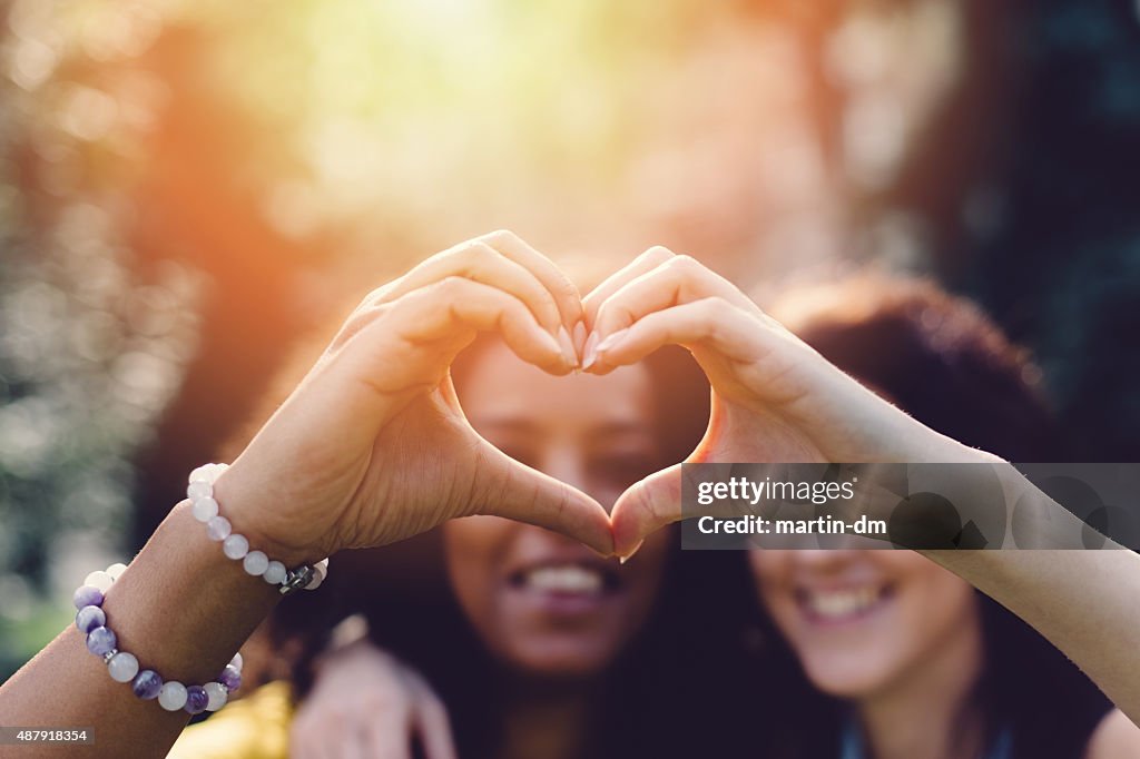 Girls making heart with hands