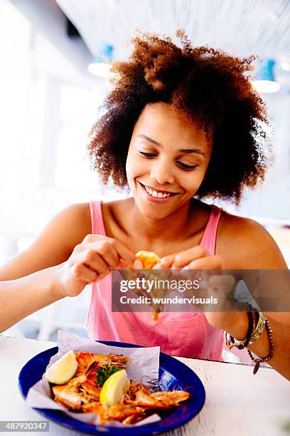 girl enjoying seafood in restaurant - shrimp seafood stockfoto's en -beelden