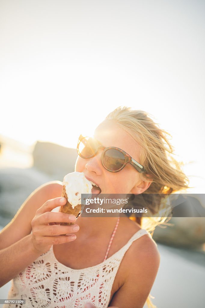 Girl eating icecream on beach