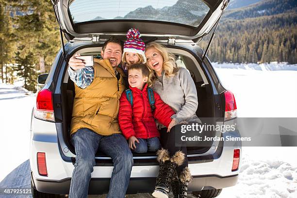 family taking self portrait on tailgate - four people in car fotografías e imágenes de stock