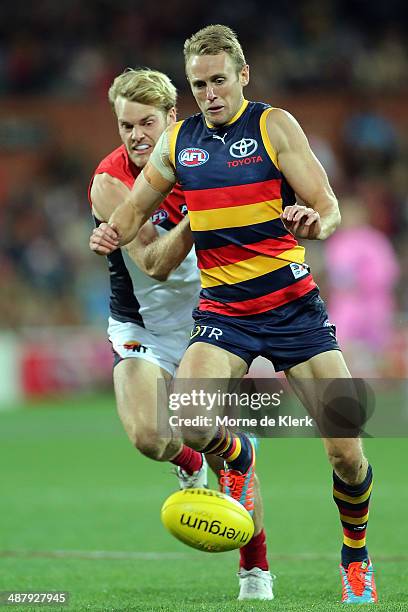Brent Reilly of the Crows competes for the ball with Jack Watts of the Demons during the round seven AFL match between the Adelaide Crows and the...