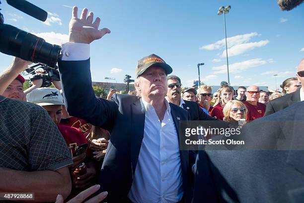 Republican presidential candidate Donald Trump greets fans tailgating outside Jack Trice Stadium before the start of the Iowa State University versus...