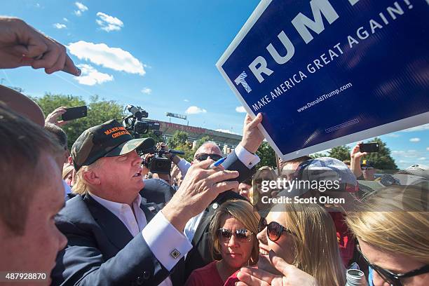 Republican presidential candidate Donald Trump greets fans tailgating outside Jack Trice Stadium before the start of the Iowa State University versus...