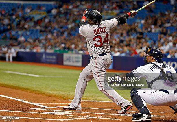David Ortiz of the Boston Red Sox hits his 499th career MLB home run, a three-run home run in front of catcher J.P. Arencibia of the Tampa Bay Rays,...