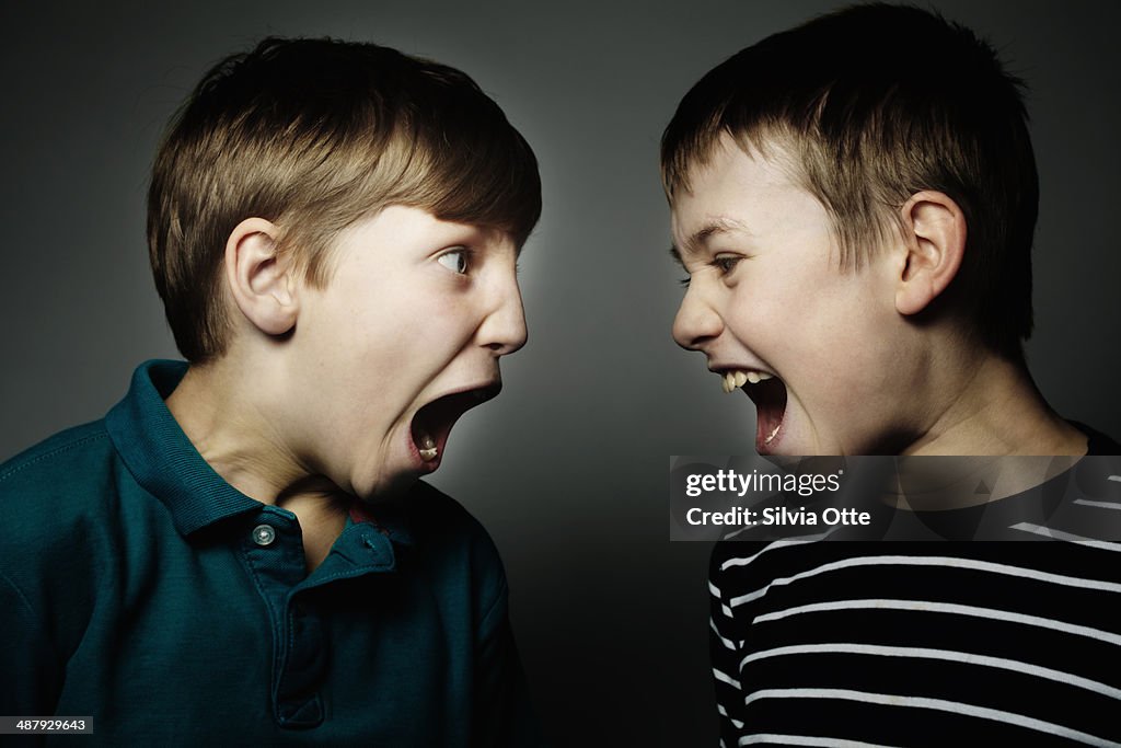 Two boys shouting at each other