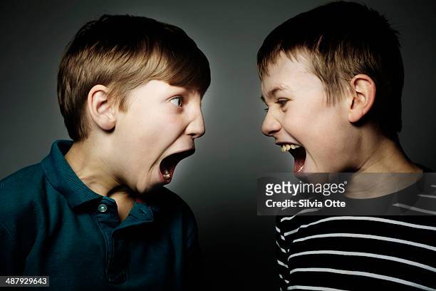 two boys shouting at each other - volume 2 stock pictures, royalty-free photos & images