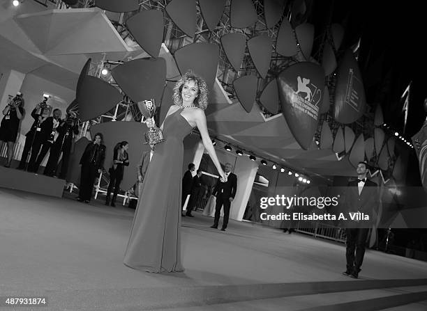 Winner of the Coppa Volpi for best Actress Award Valeria Golino shows her award on the red carpet during the 72nd Venice Film Festival on September...