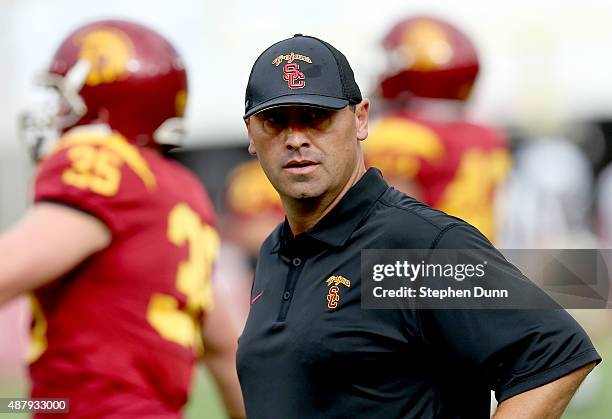 Head coach Steve Sarkisian of the USC Trojans watches his team during warmups for the game with the Idaho Vandals at Los Angeles Memorial Coliseum on...