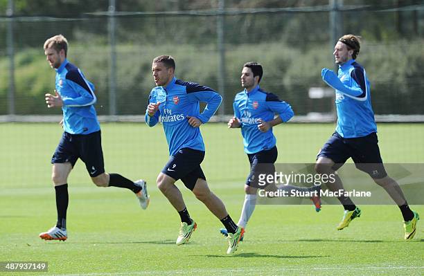 Per Mertesacker, Lukas Podolski, Mikel Arteta and Nicklas Bendtner of Arsenal during a training session at London Colney on May 3, 2014 in St Albans,...