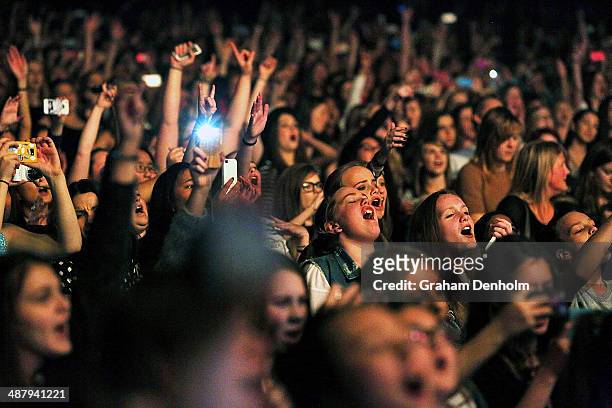 Young fans sing along as 5 Seconds of Summer perform on stage at the Palais Theatre on May 3, 2014 in Melbourne, Australia.