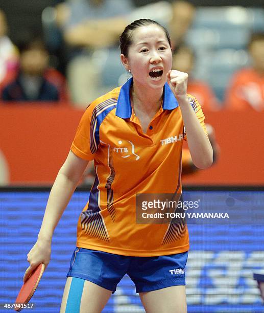 Li Jie of the Netherlands reacts after winning a point against Yuka Ishigaki of Japan during their women's team quarter-final match of the 2014 World...