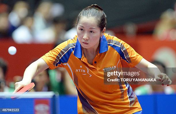 Li Jie of the Netherlands returns a shot against Yuka Ishigaki of Japan during their women's team quarter-final match of the 2014 World Team Table...