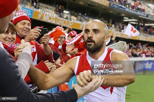 Rhyce Shaw of the Swans celebrates with fans after playing his 200th game and winning the round seven AFL match between the Brisbane Lions and the...