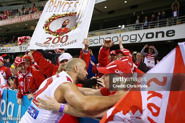 Rhyce Shaw of the Swans celebrates with fans after playing his 200th game and winning the round seven AFL match between the Brisbane Lions and the...