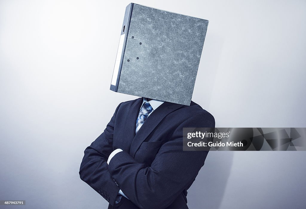 Business man wearing a folder as head.