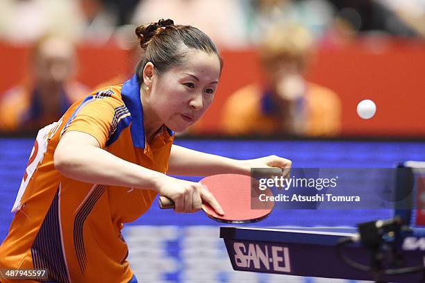 Jie Li of Netherlands plays a backhand against Yuka Ishigaki of Japan during day six of the 2014 World Team Table Tennis Championships at Yoyogi...