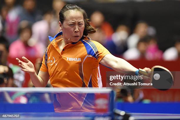 Jiao Li of Netherlands plays a forehand against Kasumi Ishikawa of Japan during day six of the 2014 World Team Table Tennis Championships at Yoyogi...