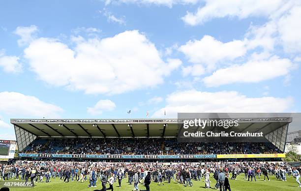 Millwall fans invade the pitch at the final whistle after Millwall avoid relegation during the Sky Bet Championship match between Millwall and...