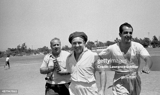 View of American gangster Mickey Cohen , and unidentified others, on a lot across from the Twentieth Century Fox Studios, Los Angeles, California,...