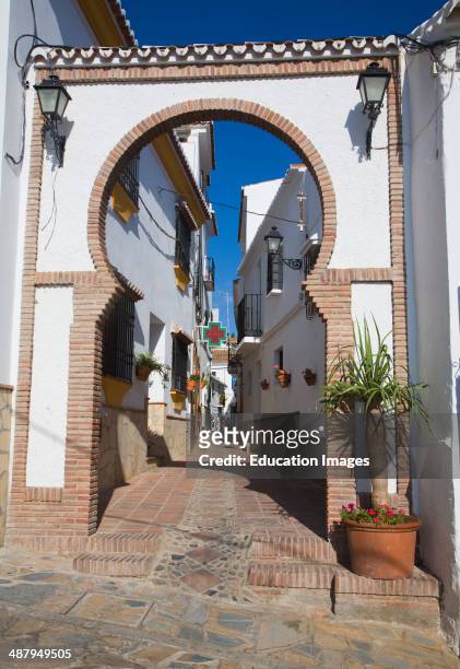 Moorish archway architectural feature and alleyway in the Andalusian village of Comares, Malaga province, Spain.
