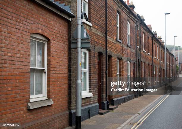 Street of red brick nineteenth century terraced housing in the town of Cromer, north Norfolk, England.