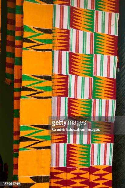 Colorful kente cloth produced in the weaving craft village of Adanwomase in the Ashanti Region of Ghana, West Africa. Kente cloth is worn by Ghana...