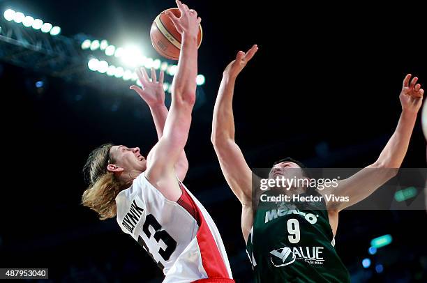 Kelly Olynyk of Canada handles the ball against Francisco Cruz of Mexico during a third place match between Canada and Mexico as part of the 2015...