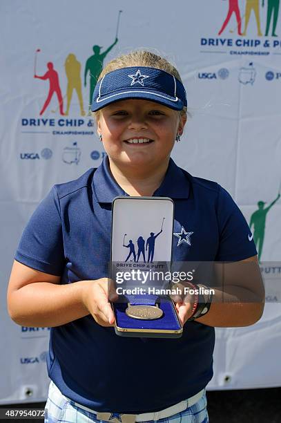Avery Zweig poses for a photo after winning first place overall t a Regional Finals for 7-9 year old girls at the Drive, Chip and Putt competition on...