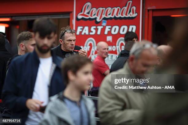 Fans eat fish and chips from the Legends Fast Food store near Old Trafford during the Barclays Premier League match between Manchester United and...