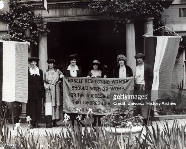 Photograph of six suffragists at the 1920 Republican National Convention in Chicago, gathered in front of a building with suffrage banners. Mrs....