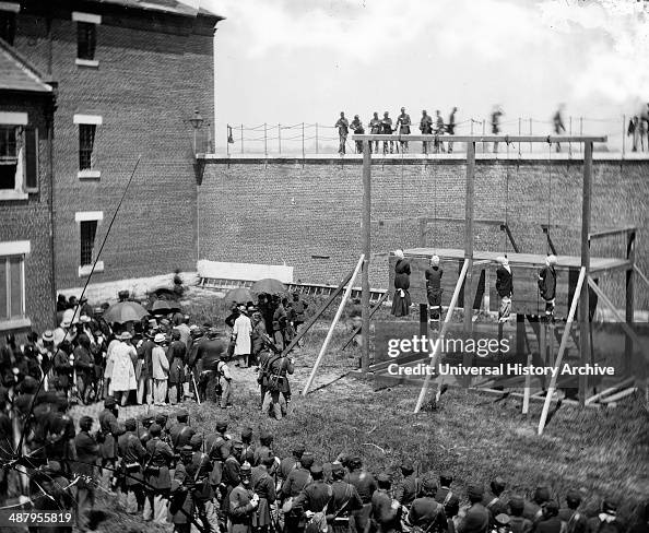 Washington, D.C. Hanging hooded bodies of the four conspirators; crowd departing 1865 July.