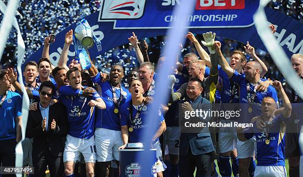 Wes Morgan of Leicester City lifts the Championship trophy after the Sky Bet Championship match between Leicester City and Doncaster Rovers at The...