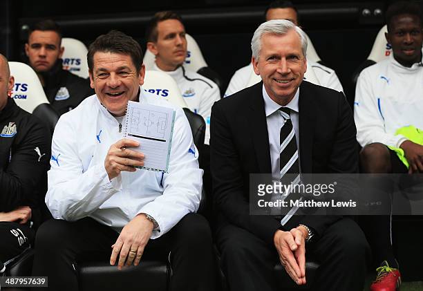 Alan Pardew manager of Newcastle United and assistant John Carver look on from the bench prior to during the Barclays Premier League match between...
