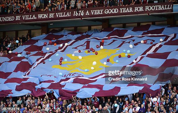 Aston Villa fans display a club flag during the Barclays Premier League match between Aston Villa and Hull City at Villa Park on May 3, 2014 in...