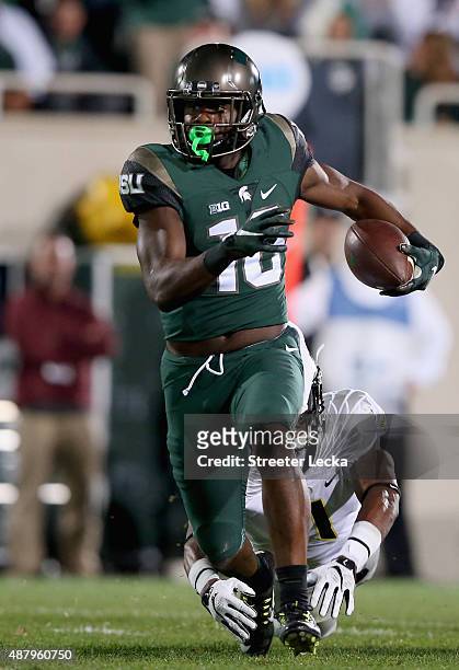 Arrion Springs of the Oregon Ducks misses a tackle against Aaron Burbridge of the Michigan State Spartans during their game at Spartan Stadium on...