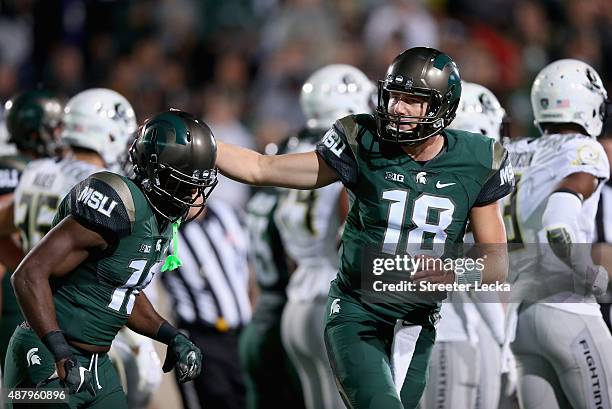 Aaron Burbridge of the Michigan State Spartans celebrates after scoring a touchdown with teammate Connor Cook against the Oregon Ducks during their...