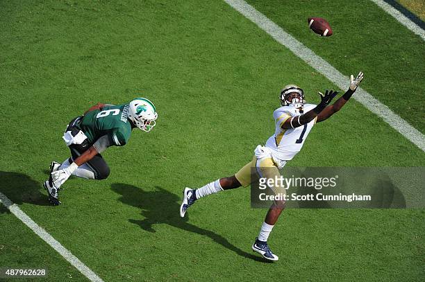 Qua Searcy of the Georgia Tech Yellow Jackets goes up for a pass against Jarrod Franklin of the Tulane Green Wave on September 12, 2015 at Bobby Dodd...