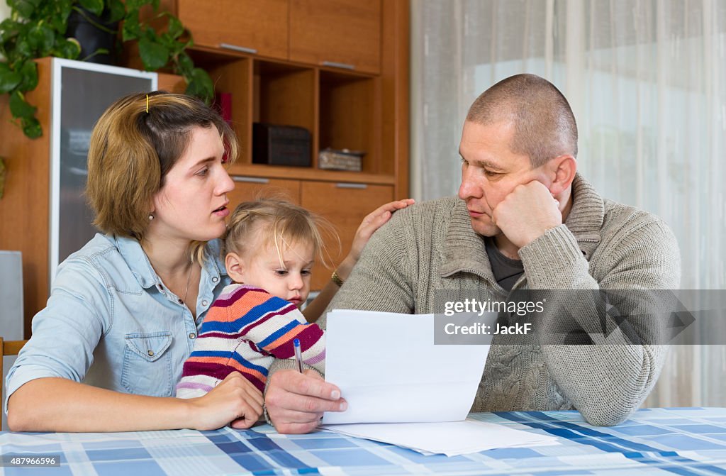 Worried family with financial documents