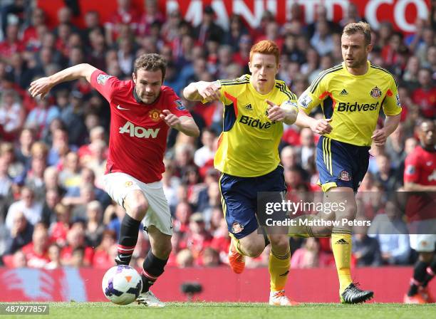 Juan Mata of Manchester United in action against Jack Colback of Sunderland during the Barclays Premier League match between Manchester United and...