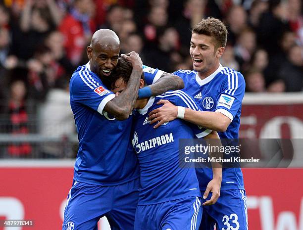 Felipe Santana, Kaan Ayhan and Roman Neustadter of Schalke 04 celebrate opening goal of Ayhan during the Bundesliga match between SC Freiburg and FC...