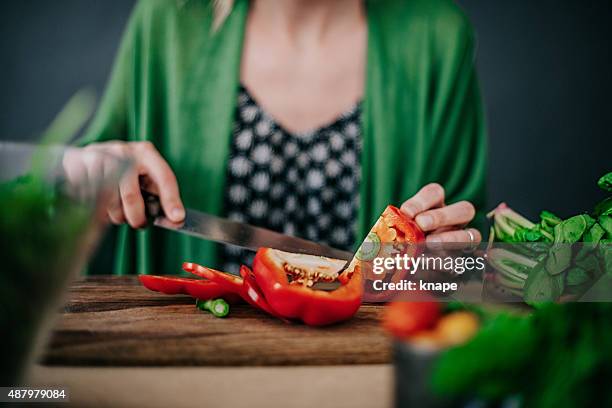 young woman making fresh salad - paprika stock pictures, royalty-free photos & images