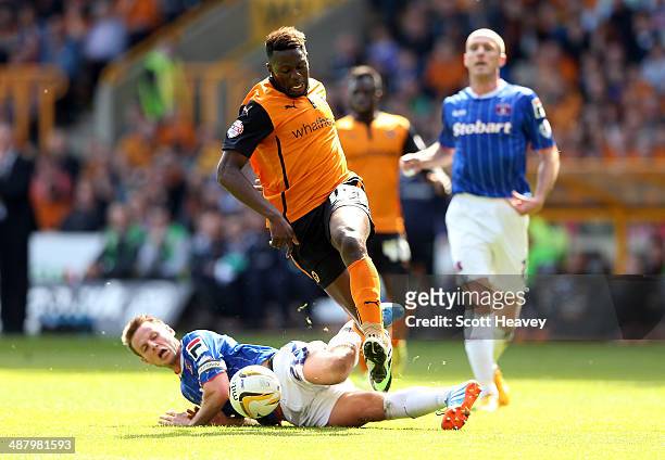 James Berrett of Carlisle slides in on Bakary Sako of Wolves during the Sky Bet League One match between Wolverhampton Wanderers and Carlisle United...