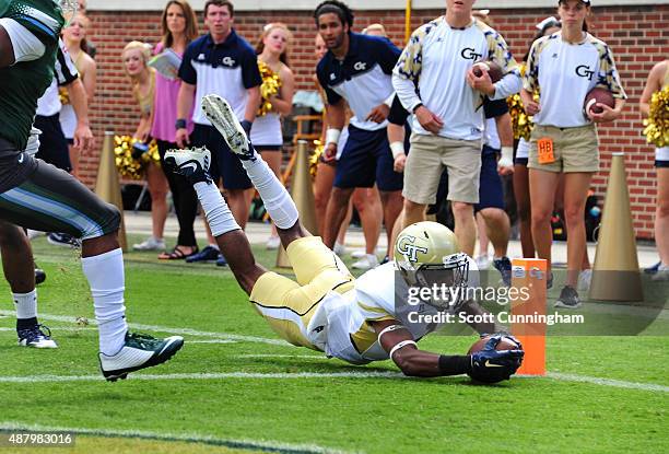 Qua Searcy of the Georgia Tech Yellow Jackets dives across the goal line for a first quarter 13 yard touchdown against the Tulane Green Wave on...