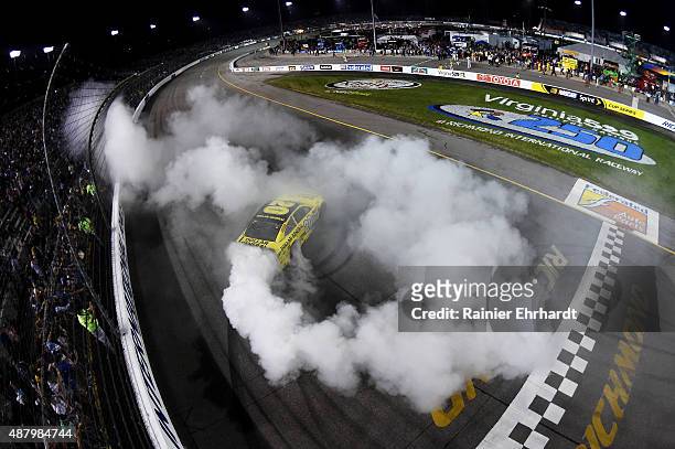 Matt Kenseth, driver of the Dollar General Toyota, celebrates with a burnout after winning the NASCAR Sprint Cup Series Federated Auto Parts 400 at...