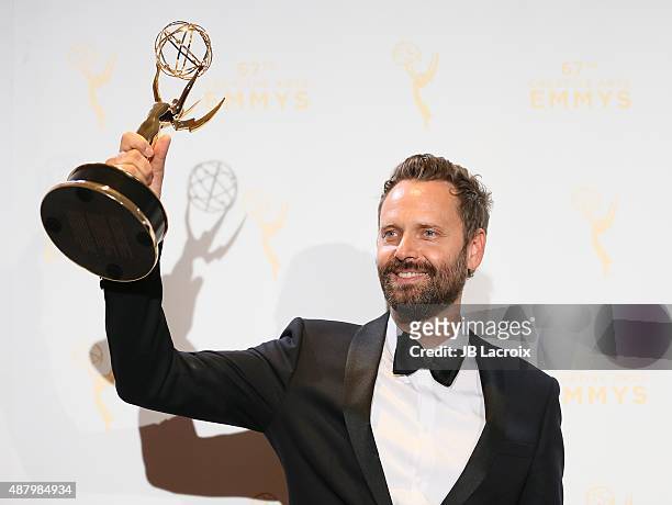 Winner of Original Main Title Theme Music Dustin O'Halloran poses in the press room during the 2015 Creative Arts Emmy Awards at Microsoft Theater on...