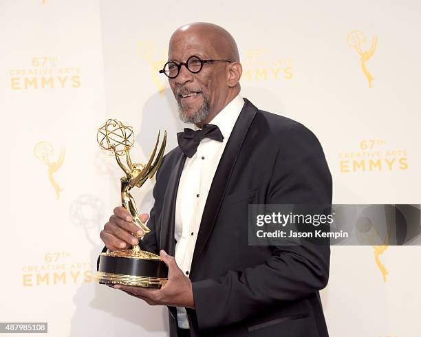 Reg E. Cathey, winner of the award for guest actor in a drama for "House of Cards," poses in the press room during the 2015 Creative Arts Emmy Awards...