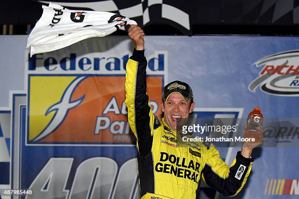 Matt Kenseth, driver of the Dollar General Toyota, celebrates in Victory Lane after winning the NASCAR Sprint Cup Series Federated Auto Parts 400 at...