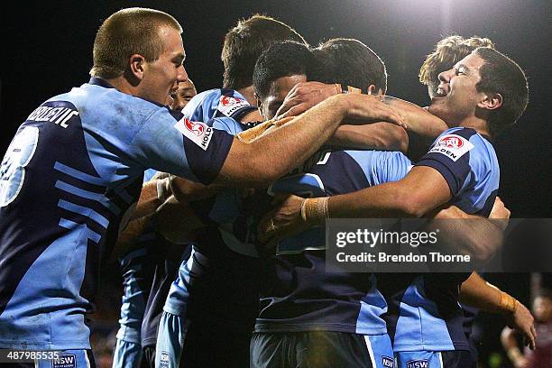 Jake Mamo of the NSW celebrates with team mates after scoring a try during the U20's State of Origin match between the New South Wales Blues and the...