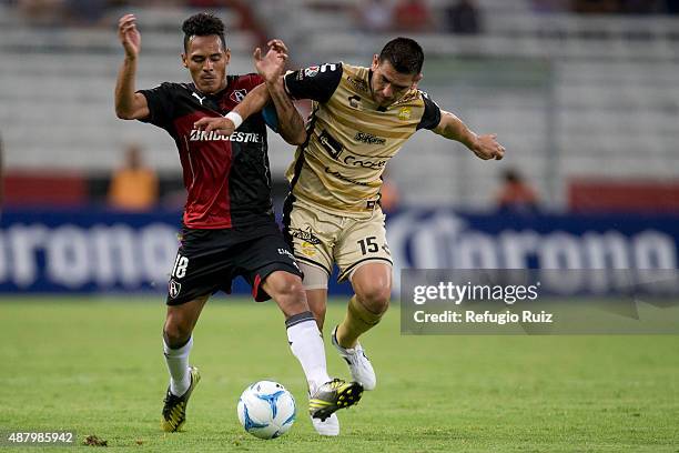 Aldo Ramirez of Atlas fights for the ball with Raul Enriquez of Dorados during an 8th round match between Atlas and Dorados de Sinaloa as part of the...